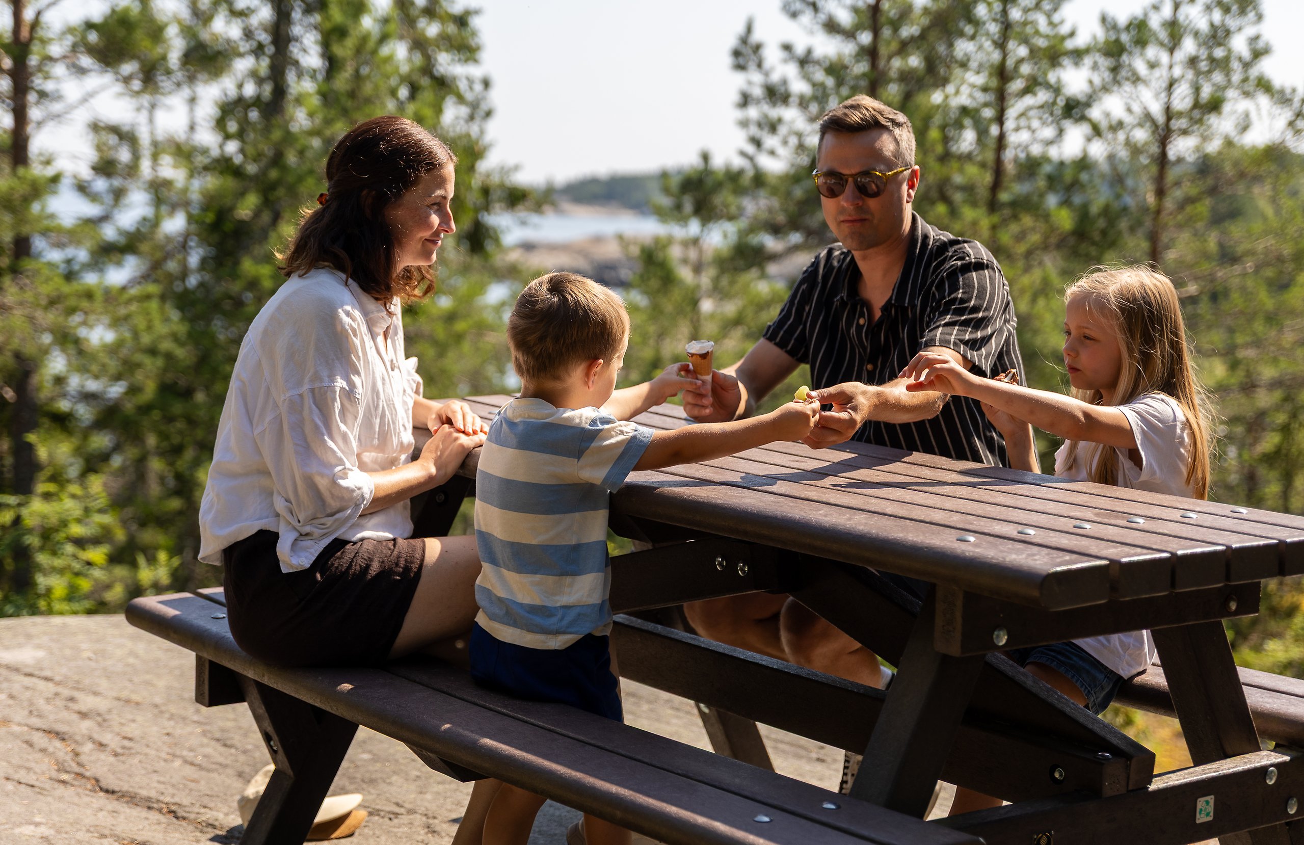 Barnfamilj som fikar vid ett bord