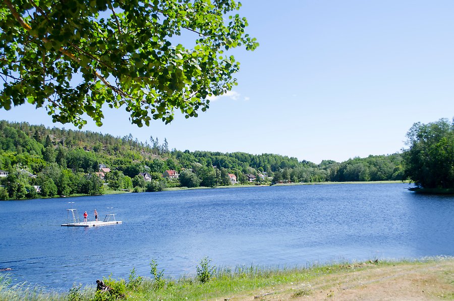 Badstrand med barn som leker ute i vattnet